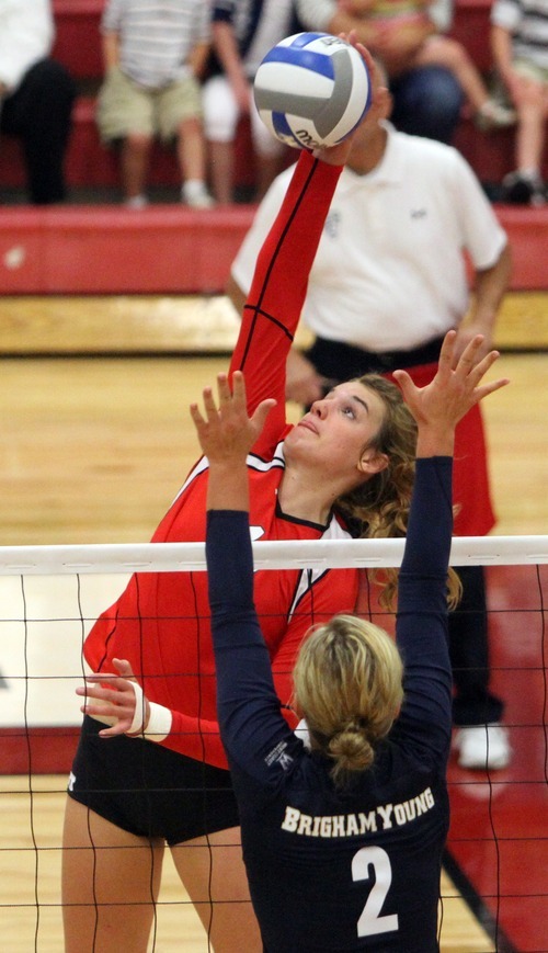 Rick Egan  | The Salt Lake Tribune 

Utah's Chelsey Schofield spikes the ball for the Lady Utes, as Heather Hannemann defends for BYU, in volleyball action, Utah vs. BYU, in Salt Lake City, Saturday, September 10, 2011.