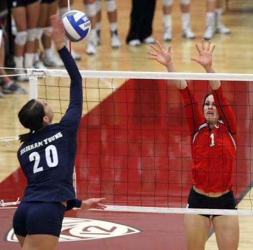 Rick Egan  | The Salt Lake Tribune 

Casey Thurston, 20, hits the ball over the net for BYU, as McKenzie Odale defends for the Lady Utes, in volleyball action, Utah vs. BYU, in Salt Lake City, Saturday, September 10, 2011.