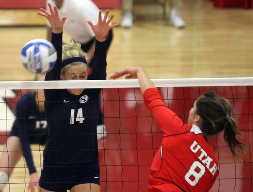 Rick Egan  | The Salt Lake Tribune 

Utah's Alli Spurrier knocks the ball past Christie Carpenter 14, in volleyball action, Utah vs. BYU, in Salt Lake City, Saturday, September 10, 2011.