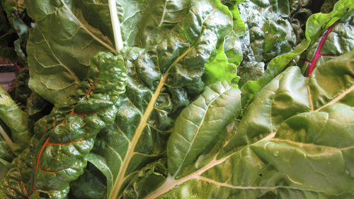 Lesli J. Neilson  |  The Salt Lake Tribune

Swiss chard comes in a variety of colors, from red-veined ribs to yellow to orange to pink, the leaves are always a deep green. Though a tinge bitter when eaten raw, chard will become more subtle and akin to spinach when cooked.