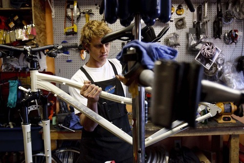 Trent Nelson  |  The Salt Lake Tribune
Kyle Hickey, a bike mechanic at work at Cottonwood Cyclery in Sandy, Utah, Tuesday, September 13, 2011. Hickey was uninsured when he blew out his knee in a ski competition last year. The total bill for three surgeries and a helicopter flight down the mountain was $120,000.
