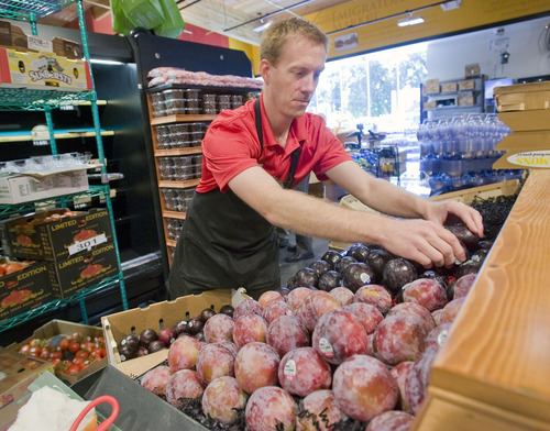 Al Hartmann  |  The Salt Lake Tribune
Mike Bradford, produce manager at the new Harmons Emmigration Market at 1700 East and 1300 South in Salt Lake City, sets up fruit and displays Monday.  The store is set to open Wednesday.