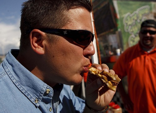 Trent Nelson  |  The Salt Lake Tribune
Dennis Stacy bites into the maggot-melt sandwich at Jungle George's Exotic Meats and Bugs, a food vendor at the Utah State Fair . The fair concludes Sunday.