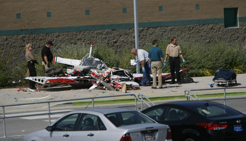 Francisco Kjolseth  |  The Salt Lake Tribune
A small single engine plane sits next to Columbia Elementary in West Jordan on Thursday, September 15, 2011, as investigators work the scene of the single fatal accident shortly after removing the pilot's body.