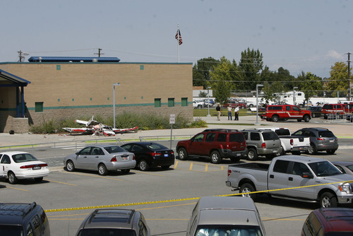 Francisco Kjolseth  |  The Salt Lake Tribune
A small single-engine plane sits next to Columbia Elementary in West Jordan on Thursday, Sept. 15, 2011, after crashing.