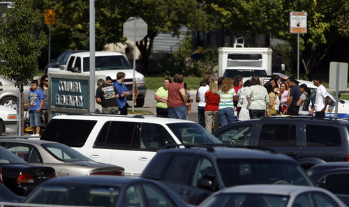 Francisco Kjolseth  |  The Salt Lake Tribune
Parents and students gather outside of Columbia Elementary in West Jordan for an update on a small single engine plane crash outside of the school on Thursday, September 15, 2011, after crashing around 12:40pm.