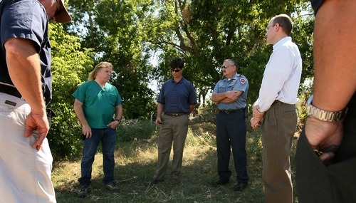 Leah Hogsten  |  The Salt Lake Tribune
Reptile expert Jim Dix, left, and West Valley City officials and planners look at abandoned farm acreage leased by Kennecott to determine if the land was suitable for a home for Dix's Reptile Rescue Services, but the location was scrapped due to lack of safe and immediate public access.