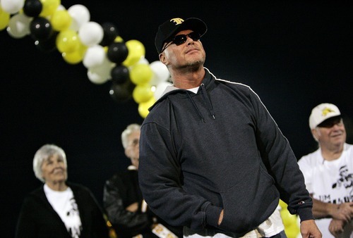 Djamila Grossman  |  The Salt Lake Tribune

Roy High School plays Box Elder High School at Roy, Utah, on Friday, Sept. 16, 2011. Former Roy football player Jim McMahon looks at the crowd before a speech, as his number was being retired during half time. McMahon went on to play in the NFL.