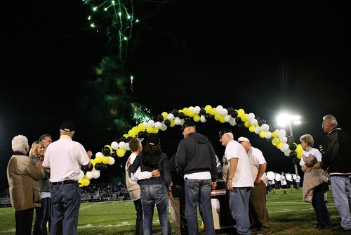 Djamila Grossman  |  The Salt Lake Tribune

Roy High School plays Box Elder High School at Roy, Utah, on Friday, Sept. 16, 2011. Former Roy football player Jim McMahon and his friends and family watch fireworks after his number was retired during half time. McMahon went on to play in the NFL.