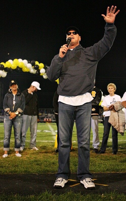 Djamila Grossman  |  The Salt Lake Tribune

Roy High School plays Box Elder High School at Roy, Utah, on Friday, Sept. 16, 2011. Former Roy football player Jim McMahon talks to the crowd before his number was retired during half time. McMahon went on to play in the NFL.