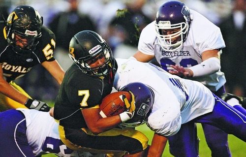 Djamila Grossman  |  The Salt Lake Tribune

Roy High School plays Box Elder High School at Roy, Utah, on Friday, Sept. 16, 2011. Roy's Jake Trujillo (7) is being tackled by Box Elder's Taylor Wilding (42) and Joe Flores (63) in the first half.