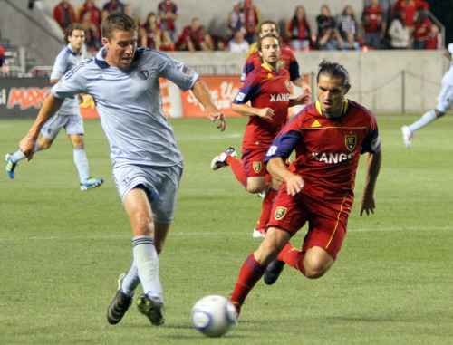 Sporting Kansas City defender Matt Besler keeps the ball from Real Salt Lake forward Fabian Espindola during RSL's 1-0 win in Rio Tinto Stadium.
Stephen Holt/ Special to the Tribune