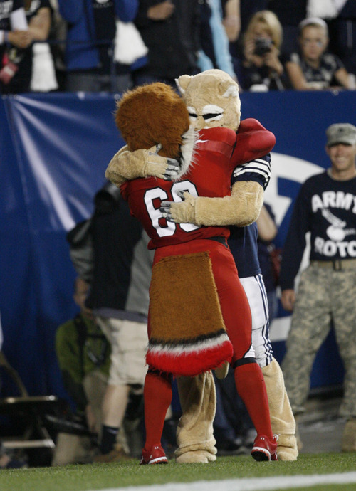 Trent Nelson | The Salt Lake Tribune

BYU mascot Cosmo the Cougar hugs Utah mascot Swoop during BYU's game against Utah at Lavell Edwards Stadium in Provo, Utah September 17, 2011.