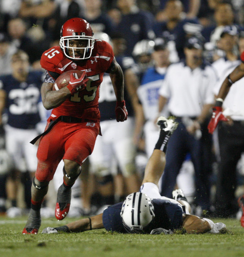 Trent Nelson | The Salt Lake Tribune

Utes running back John White IV (15 beaks a tackle on his way to the endzone during BYU's game against Utah at Lavell Edwards Stadium in Provo, Utah September 17, 2011.