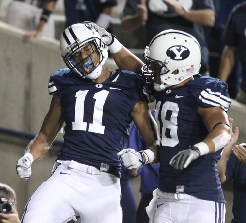 Rick Egan | The Salt Lake Tribune

BYU wide receiver Ross Apo (11) celebrates a touchdown with teammate tight end Richard Wilson (18) during BYU's game against Utah at Lavell Edwards Stadium in Provo, Utah September 17, 2011.