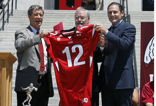 Scott Sommerdorf  |  The Salt Lake Tribune
Utah athletic director Chris Hill, left, Utah interim president Lorris Betz, and Pac-12 commissioner Larry Scott hold up a football jersey commemorating the day as the University of Utah officially became a member of the Pac-12 conference on July 1.