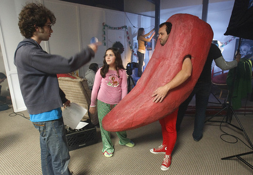 Leah Hogsten  |  The Salt Lake Tribune
Orabrush YouTube commercial director Joel Ackerman, left, directs his brother Dave Ackerman, right, who plays Morgan the Orabrush Tongue, and actress Michelle Chisholm, 13, during filming.