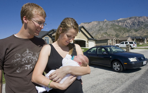 Al Hartmann  |  The Salt Lake Tribune
Ashley and Ben Marsden with their newborn son, Hawk Benjamin Marsden, after coming home from the hospital on Tuesday. Ashley gave birth along the side of Interstate 15 in Ogden in their Volkswagen Jetta on Sept. 19 as they were racing to the hospital. Ben delivered the healthy boy, the couple's fourth child.