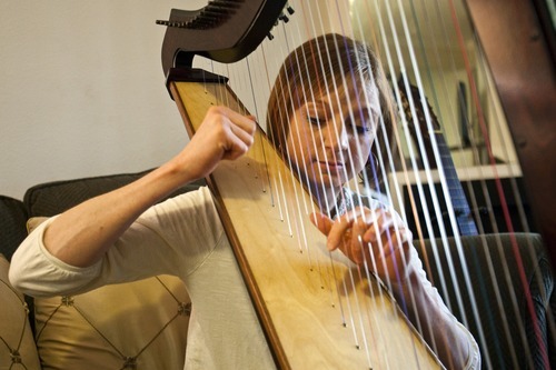 Chris Detrick  |  The Salt Lake Tribune
Chante Wouden plays the harp at her home in Bountiful Wednesday September 14, 2011.  Chante Wouden, 30, of Bountiful fought and won two bouts with Ewing's sarcoma as a child. She is among hundreds of childhood cancer survivors who benefit from a new Pediatric Cancer Late Effects Clinic at the Huntsman Cancer Institute (HCI) at the University of Utah.