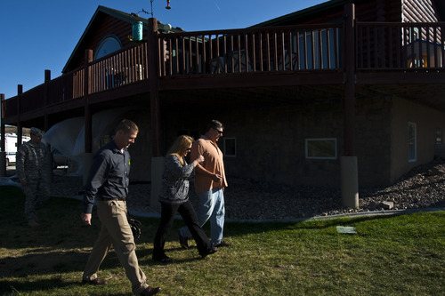 Chris Detrick  |  Tribune file photo
David and Robin Smugala show Benjamin Kinsley the remaining damage to their home in Herriman this week after a wildfire swept onto their property a year ago.