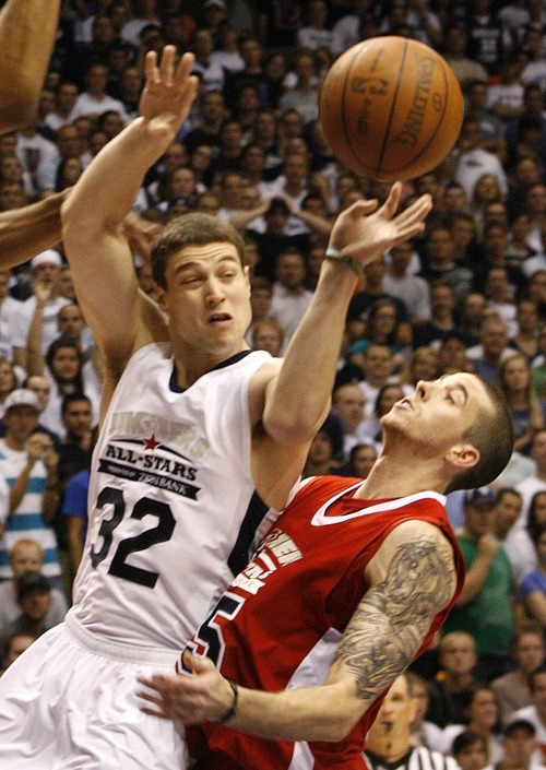 Paul Fraughton  |  The Salt Lake Tribune 
Jimmer Fredette  takes an off balance shot as Indiana State graduate Jake Kelly defends. Jimmer joined other NBA  draftees and former college players for an exhibition game at BYU's Marriott Center.
  Thursday, September 22, 2011