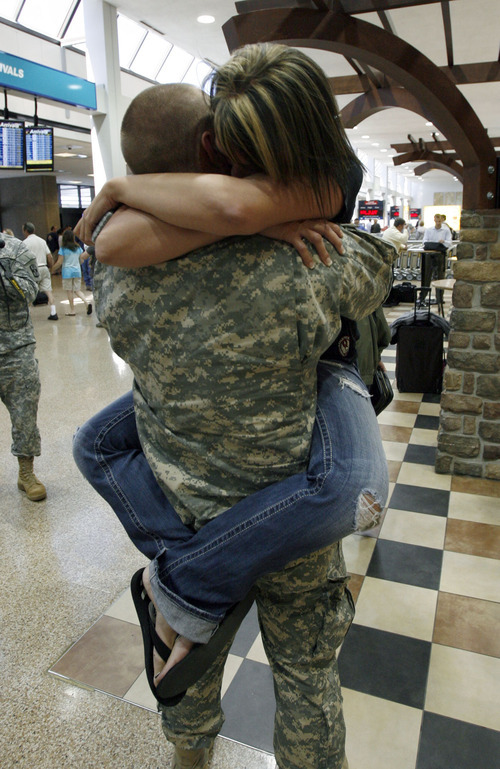Francisco Kjolseth  |  The Salt Lake Tribune
Roy Coates of Sandy embraces his girlfriend Jen Jorgensen as part of the first wave of approximately 40 soldiers from the 971st Medical Logistics Company (Army Reserve) in Ogden returns from deployment to Afghanistan on Wednesday, Sept. 21, 2011, at Salt Lake City International Airport. The 971st Medical Company's one-year mission was mostly the shipping and receiving of medical supplies.