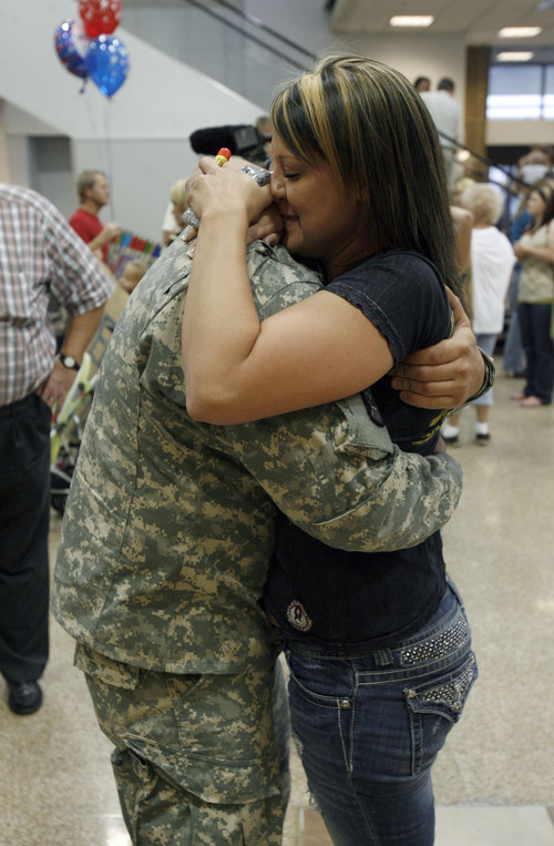 Francisco Kjolseth  |  The Salt Lake Tribune
Roy Coates of Sandy embraces his girlfriend Jen Jorgensen as part of the first wave of approximately 40 soldiers from the 971st Medical Logistics Company (Army Reserve) in Ogden returns from deployment to Afghanistan on Wednesday, Sept. 21, 2011, at Salt Lake City International Airport. The 971st Medical Company's one-year mission was mostly the shipping and receiving of medical supplies.