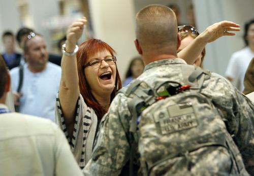 Francisco Kjolseth  |  The Salt Lake Tribune
Tracy Turnidge throws her arms around her brother Jeff Franklin after arriving in the first wave of approximately 40 soldiers from the 971st Medical Logistics Company (Army Reserve) in Ogden returning from deployment to Afghanistan on Wednesday, Sept. 21, 2011, at Salt Lake City International Airport. The 971st Medical Company's one-year mission was mostly the shipping and receiving of medical supplies.