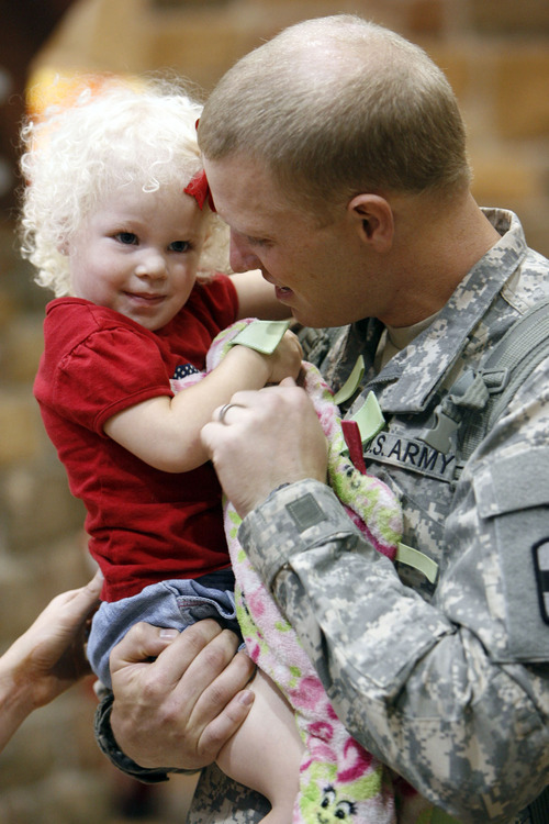Francisco Kjolseth  |  The Salt Lake Tribune
Aaron DeHart of Ogden greets his daughter Isabel, 2, after spending the last year communicating with her and his wife Anica through gmail chat. The first wave of approximately 40 soldiers from the 971st Medical Logistics Company (Army Reserve) in Ogden returned from deployment to Afghanistan on Wednesday, Sept. 21, 2011, at Salt Lake City International Airport. The 971st Medical Company's one-year mission was mostly the shipping and receiving of medical supplies.