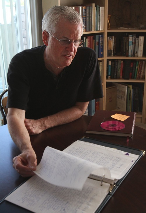 Tribune file photo
Steve Powell thumbs through pages in Susan Powell's journal, at his home in Puyallup Washington on Aug. 20. Steve Powell, father of Joshua Powell, was arrested Thursday and charged with 14 counts of voyeurism and possession of depictions of minors engaged in sexually explicit conduct in the second degree.