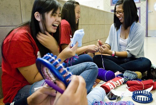 Djamila Grossman  |  The Salt Lake Tribune
From left: University of Utah biology sophomore Anna Nguyen, psychology and human development sophomore Kimberly Nguyen, and biology junior Jenn Nhan, make hats for newborns at Mountain View Elementary School in Salt Lake City on Saturday. The activity was part of the University of Utah's 8th Annual Legacy of Lowell Community Service Day, with volunteers working on projects across the city.
