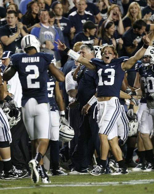 Trent Nelson  |  The Salt Lake Tribune
BYU quarterback Riley Nelson (13) celebrates a kick return touchdown by Cody Hoffman (2). BYU vs. Central Florida, college football at LaVell Edwards Stadium in Provo, Utah, Friday, September 23, 2011.
