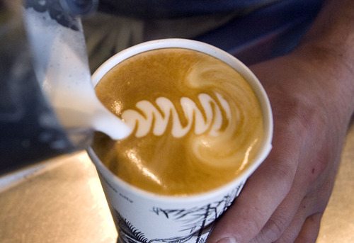 Steve Griffin  |  The Salt Lake Tribune


Basil Eisenman, a barista at the Coffee Garden in Salt Lake City, puts a leaf design on the top of a latte Monday, Sept. 26, 2011.