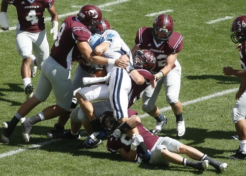 Chris Detrick  |  The Salt Lake Tribune
Jordan's Tayler Dean (9) Jordan's Tyler Swan (8) and Jordan's Brayden Wolf (90) tackle Notre Dame's Billy Reed (16) during the game at Rio Tinto Stadium Saturday September 24, 2011. Jordan won the game 39-0.