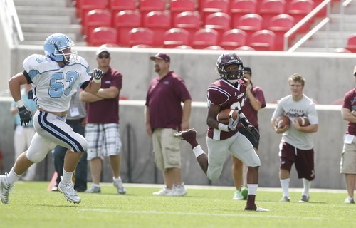 Chris Detrick  |  The Salt Lake Tribune
Jordan's Kalin Huntsman (23) runs past Notre Dame's Sam White (53) during the game at Rio Tinto Stadium Saturday September 24, 2011. Jordan won the game 39-0.