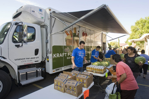 Paul Fraughton  |  The Salt Lake Tribune
 
Volunteers from Kraft Foods help people load boxes with food  from the Utah Food Bank's new Kraft Foods Mobile Pantry. The food pantry truck was unveiled at Adventure Liberty Park Church on 700 East and 1300 South in Salt Lake City. The truck is one of 25 that Kraft Foods has donated to food banks across the country.  The mobile unit, which has a refrigerated section, will expand the outreach of the food bank to underserved areas providing staples as well as fresh fruits and vegetables to those in need.