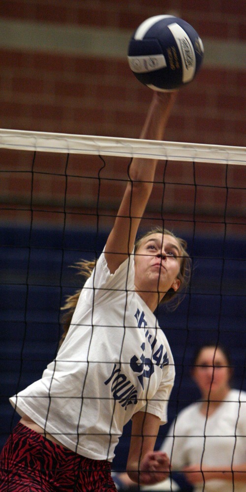 Steve Griffin  |  The Salt Lake Tribune
Waterford's Kelly Brunken spikes the ball during practice. She is now playing without her scoliosis brace. After the doctors squeezed her together -- literally -- she ended up being 1.5 inches taller.