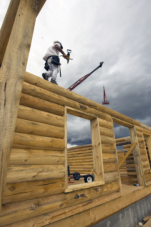 Al Hartmann  |  The Salt Lake Tribune
Carpenter Duane Platt works on a log home at Thousand Lake Lumber in Lyman.  The company works with the U.S. Forest Service in timber salvage sales.