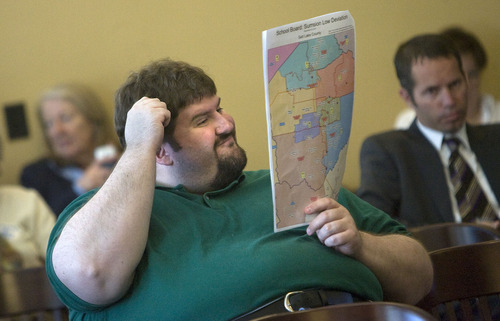 Al Hartmann  |  The Salt Lake Tribune

Chad Smith, of West Valley City, looks at maps at the Legislature's Redistricting Committee hearing on Tuesday. Much of the focus was on approving a new map for Utah's four congressional districts. The approved plan splits Salt Lake County three ways and Democrats criticized it as an example of gerrymandering. Republicans defended it as fair and balanced.