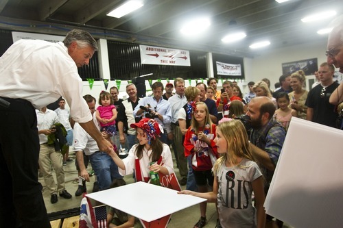 Chris Detrick | Tribune file photo
Presidential candidate Jon Huntsman talks with supporters at Plaza Cycle in West Valley City on July 16.
