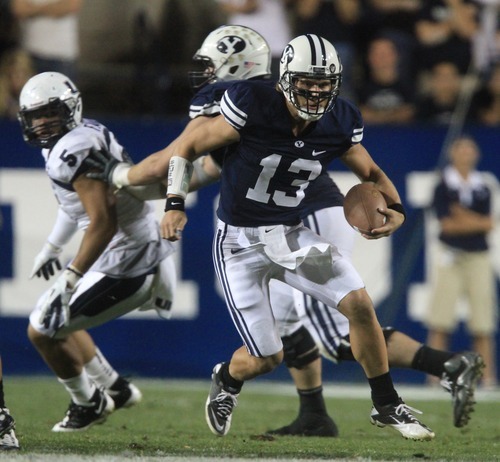 Rick Egan  | The Salt Lake Tribune 

 Brigham Young Cougars quarterback Riley Nelson (13) runs the ball on a quarterback keeper, as BYU defeated Utah State, 27-24 in Provo, Friday, September 30, 2011.
