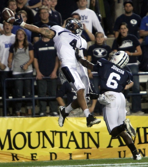 Rick Egan  | The Salt Lake Tribune 

 Utah State Aggies wide receiver Matt Austin (4) cant quite get his hand on the ball in the end zone, as  Brigham Young Cougars defensive back Jordan Johnson defends on the play, in football action, BYU vs Utah State,  in Provo, Friday, September 30, 2011