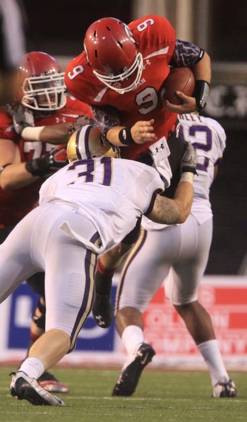 Rick Egan  | The Salt Lake Tribune 

Washington Huskies linebacker Cort Dennison (31) picks up  Utah Utes quarterback Jon Hays (9), in Pac-12 action, Utah vs. University of Washington, at Rice-Eccles stadium, Saturday, October 1, 2011.