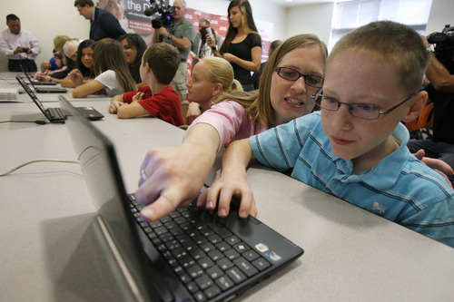 Francisco Kjolseth  |  The Salt Lake Tribune
Stephanie Rivera and her son Jayden, 11, look up information on his school, Rose Park Elementary, on a new donated computer. Lt. Gov. Greg Bell and Rodrigo Lopez, regional vice president of Comcast Cable Corp., announced a new program  to help connect low-income families to the Internet on Monday, Oct. 3, 2011.
