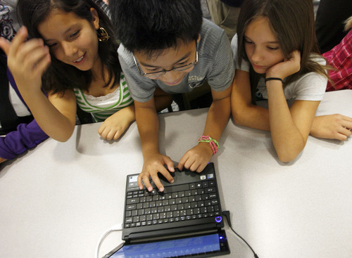 Francisco Kjolseth  |  The Salt Lake Tribune
11-year-old Reyna Coria, left, Denzyl Joson and Alexus Martinez, of Rose Park Elementary School, look up information after the announcement of a national initiative called Internet Essentials to help low-income families connect to the internet on Monday, Oct. 3, 2011.