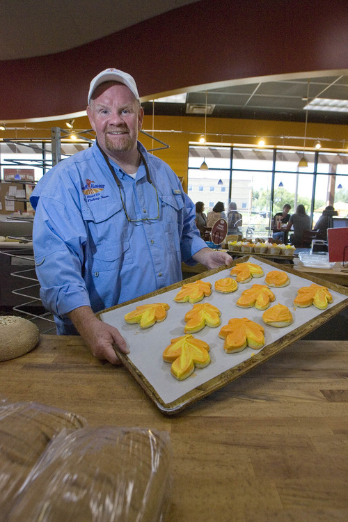 Paul Fraughton  |  The Salt Lake Tribune 
Rand Kunz shows off a tray of frosted sugar cookies, one of the  many baked goods featured at the Great Harvest Bread Co. The Taylorsville bakery makes more than $1 million in sales annually.