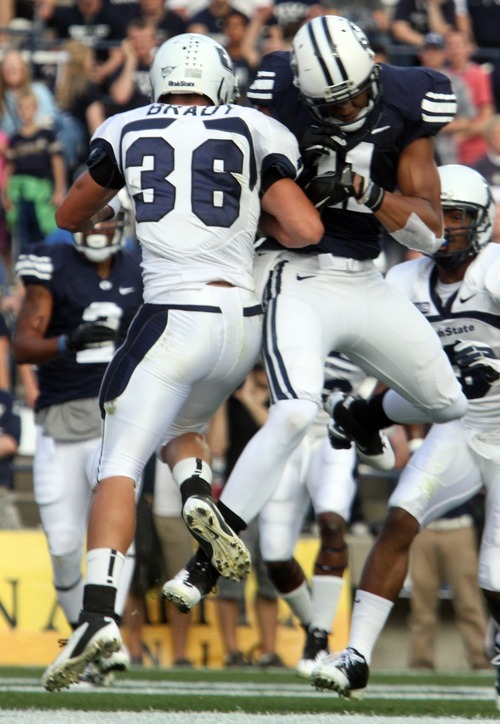 Rick Egan  | The Salt Lake Tribune 

Utah State Aggies cornerback McKade Brady hits Brigham Young Cougars  receiver Ross Apo during a game in Provo on Friday. Brady was ejected from the game following the play.