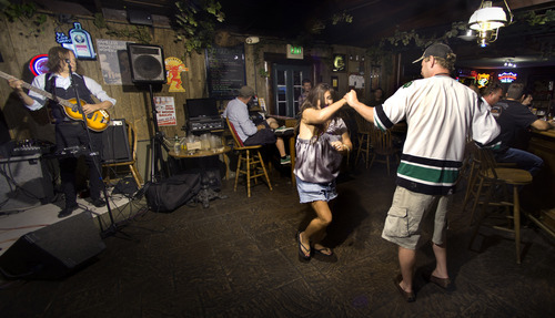 Douglas C. Pizac | Special to The Salt Lake Tribune
Patrons Sam and Christie enjoy themselves at The Hog Wallow Pub in the Old Mill neighborhood.