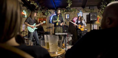 Douglas C. Pizac | Special to The Salt Lake Tribune
Patrons listen to Revolver band members Jason Sawyer, John Davis and Stephen Valdean perform at The Hog Wallow Pub.