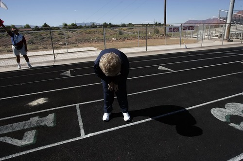 Tribune file photo
This year marks the 25th anniversary of the Huntsman World Senior Games. In this photo from the 2006 games, Ruby Shippen Call, 83, of Arizona, bends down after passing the baton to her sister during a relay race.